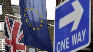 A British Union flag and a European Union flag hang from a building behind a traffic sign in central London, Britain February 17, 2016. European Union governments haggled over reform proposals on Wednesday, with pressure mounting on leaders to close remaining gaps and produce a summit deal on Friday that can help keep Britain in the EU.   REUTERS/Toby Melville